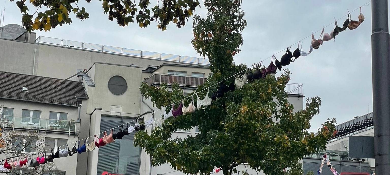 zu sehen sind BHs die über dem Platz am Kolk hängen